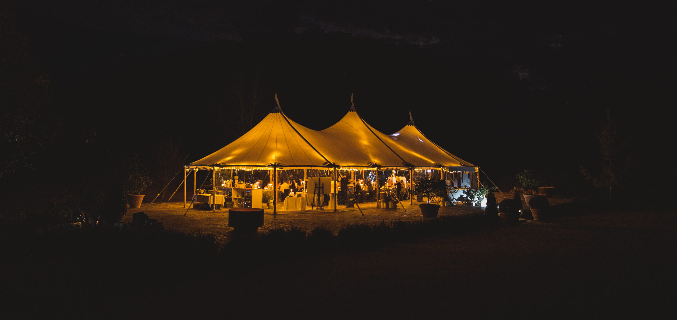 Elegant outdoor party setup with marquee and styling